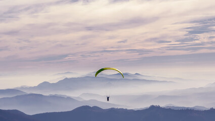 Paragliding at sunset. Against the backdrop of the beautiful Carpathian mountains. Fogs in the...