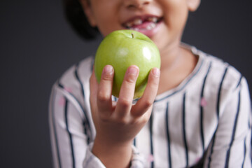  child girl hand hold a apple selective focus 