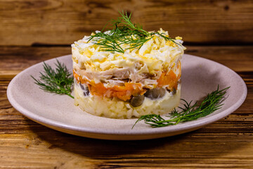 Salad with chicken breast, marinated mushrooms, carrot, eggs, boiled potato and mayonnaise on a...