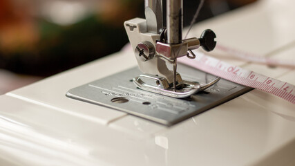 Sewing machine foot. Workplace for sewing and repairing clothes. Needle and thread