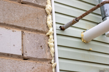 Wall cladding with siding. Foaming insulation with polyurethane foam. Gas and ventilation pipes