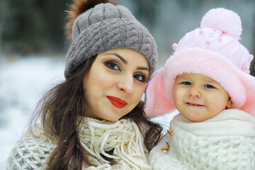 Happy family playing and laughing in winter outdoors in the snow. City park winter day.