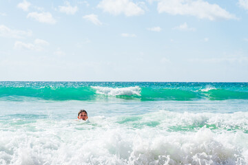 Fototapeta na wymiar Boy playing in sea, head shot, Alvor, Algarve, Portugal, Europe