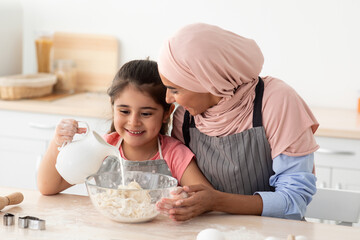 Cooking Together. Muslim Mother Baking With Her Little Daughter In Kitchen