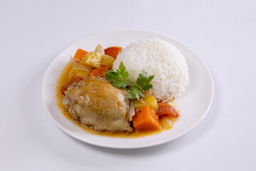 Rice and chicken stew with potatoes and carrots on white background