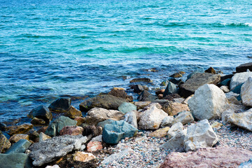 Fototapeta na wymiar Colored boulders at the edge of the sea. Stones. Marine nature.