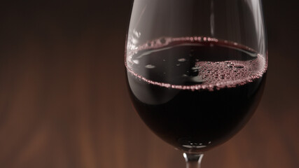 Pour red wine into wineglass closeup with copy space