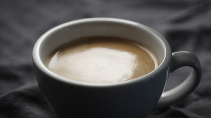 white cup with cappuccino closeup