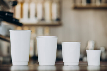 Cardboard coffee cups on table in a coffee shop