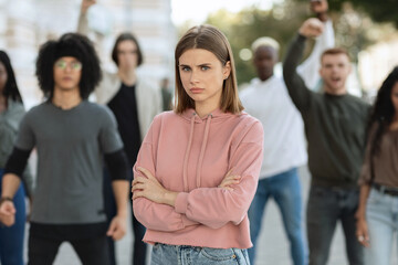 Angry lady posing over multiracial group of activists