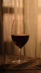 red wine in wineglass with sunset light