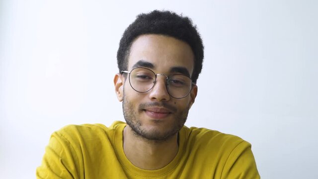 African guy smiles confidently. Smart educated student with glasses