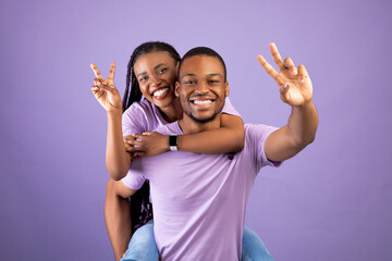 African American man giving piggyback ride for his lady