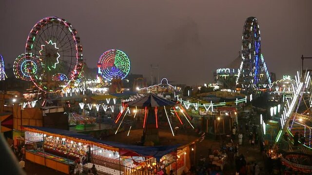 Indian carnival with colorful light decorated on Ferris giant wheel