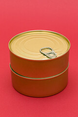 A Group of Stacked Tin Cans with Blank Edges on Red Background. Canned Food. Different Aluminum Cans for Safe and Long Term Storage of Food. Steel Sealed Food Storage Containers