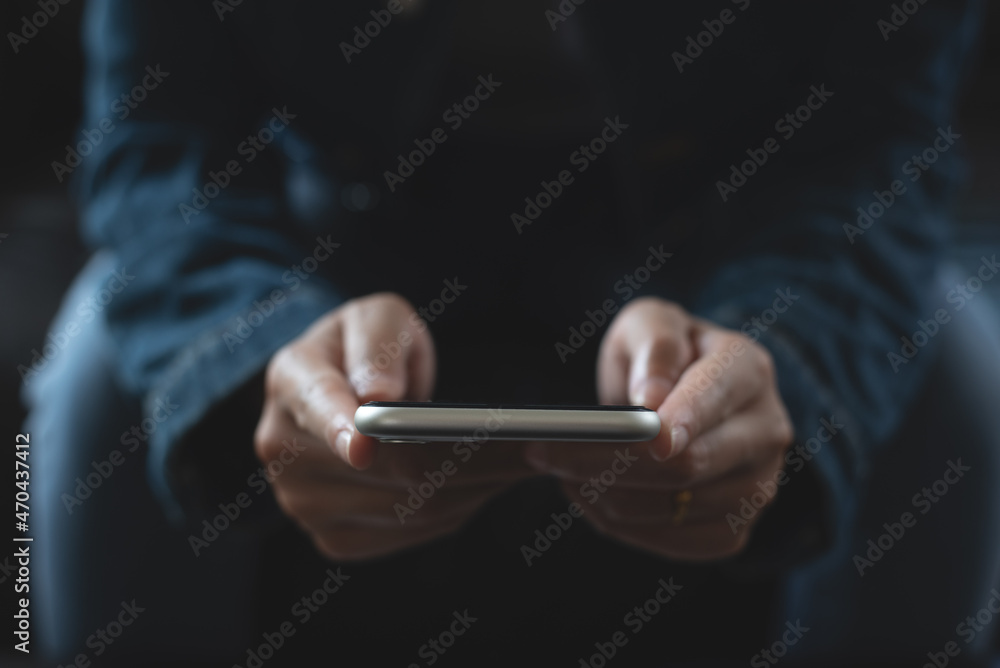 Wall mural close up of young woman in blue jeans and sweater using smart mobile phone for online shopping or so