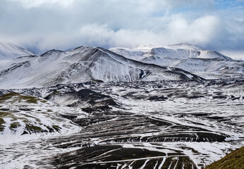 Season changing in southern Highlands of Iceland. Colorful Landmannalaugar mountains under snow...