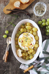 Camembert cheese fondue with grapes, thyme and white wine