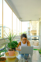 Young woman working from home on her laptop computer.