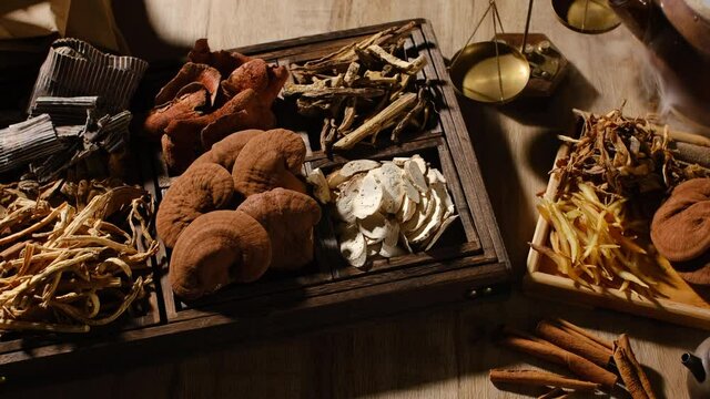 Lighting of herb and species with smoke mushroom anise turmeric in a wooden tray for traditional medicine advertising , top view