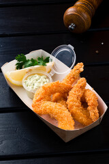 food delivery, takeaway food with fried shrimps in batter in paper containers