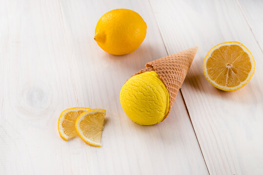 lemon ice cream with lemon in a cone on a white background