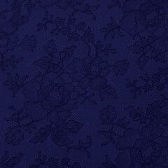 Blue lace fabric with a floral ornament. Subtle pattern in romantic vintage style. 