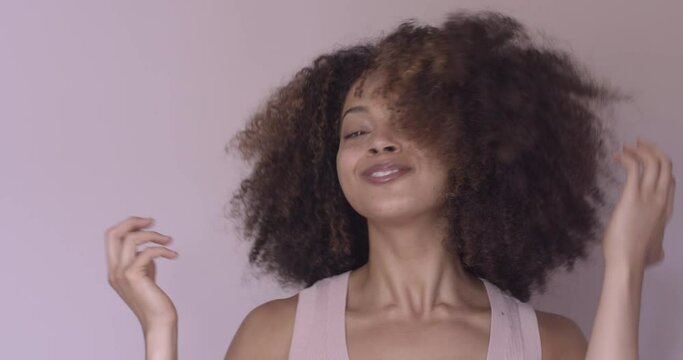 Portrait of happy young adult female with beautiful natural afro hair