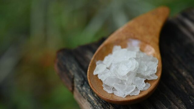Borneol camphor ,crystal on an old wood and on nature background.