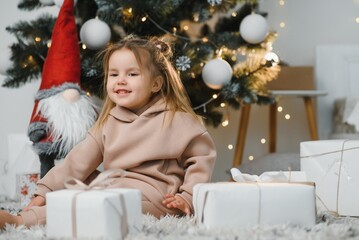 Little cute girl near christmas tree