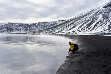 Person touches warm water in Antarctica © David Katz