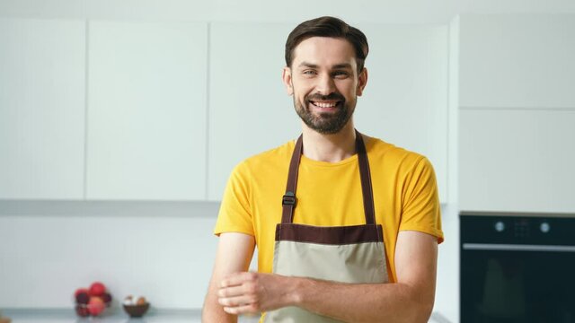 Positive guy ready do tasty supper cross arms in kitchen