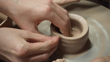Learning the art of sculpting pottery on a potter's wheel