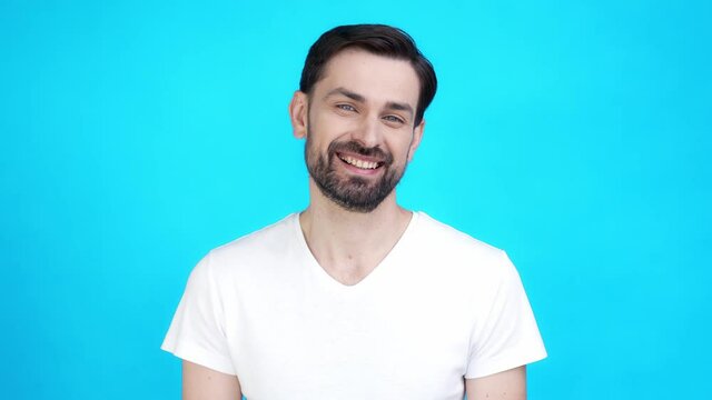 Glad guy look toothy smiling in camera isolated on blue color background