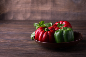 Fresh organic red, yellow and green bell peppers on a wooden background. Healthy eating. Farm product.