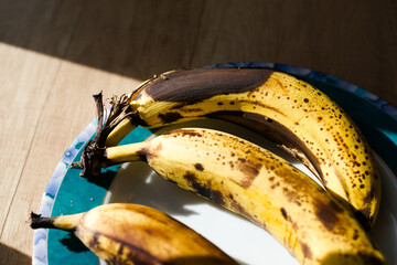 Mocno dojrzałe banany leżące na słońcu - obrazy, fototapety, plakaty