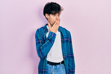 Handsome hipster young man wearing casual white t shirt and vintage shirt bored yawning tired covering mouth with hand. restless and sleepiness.