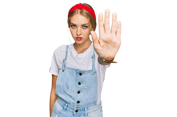 Obraz na płótnie Canvas Young caucasian girl wearing casual clothes doing stop sing with palm of the hand. warning expression with negative and serious gesture on the face.