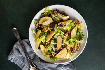 Fresh Waldorf salad with lettuce, green apples, walnuts and celery on wooden table. Top view.Copy space