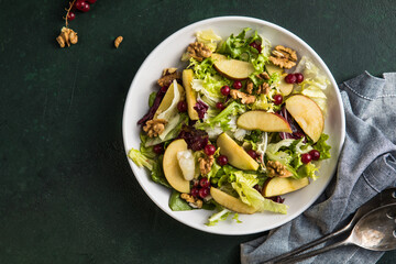 Fresh Waldorf salad with lettuce, green apples, walnuts and celery on wooden table. Top view.Copy space