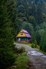 Wooden house for tourists in the autumn Carpathian forest.