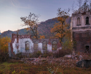 Ruined and abandoned houses in the Akarmara mining village in Abkhazia. Ghost town in the evening.