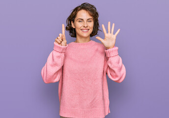 Young hispanic woman wearing casual clothes showing and pointing up with fingers number six while smiling confident and happy.