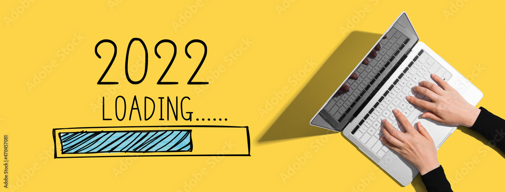 Poster loading new year 2022 with person using a laptop computer