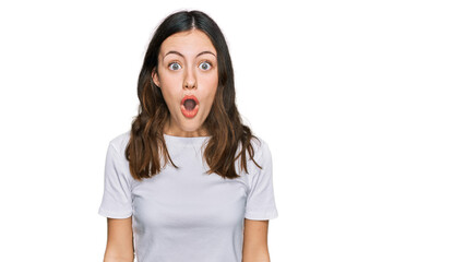 Young beautiful woman wearing casual white t shirt afraid and shocked with surprise and amazed expression, fear and excited face.