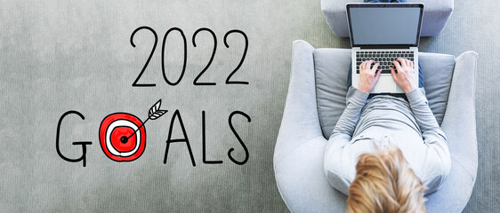 2022 Goals with man using a laptop in a modern gray chair
