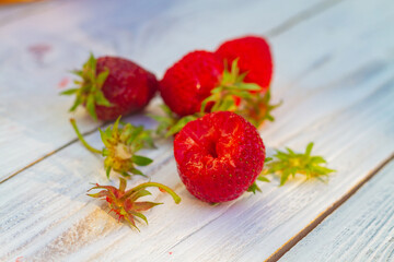 Fototapeta na wymiar Eat red juicy strawberries on a summer day