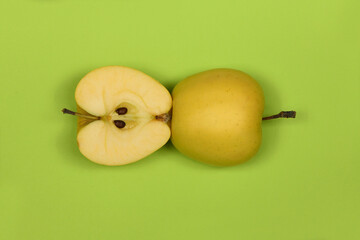 Yellow apple isolated on green.