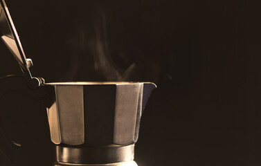 Black moka pot and steam  on a black background