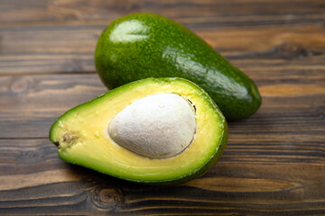 Close-up of an avocado on a wooden background. Healthy food concept.